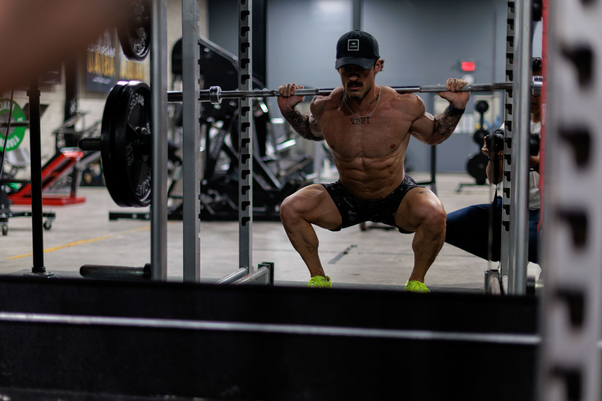 The coach is posing at the gym.