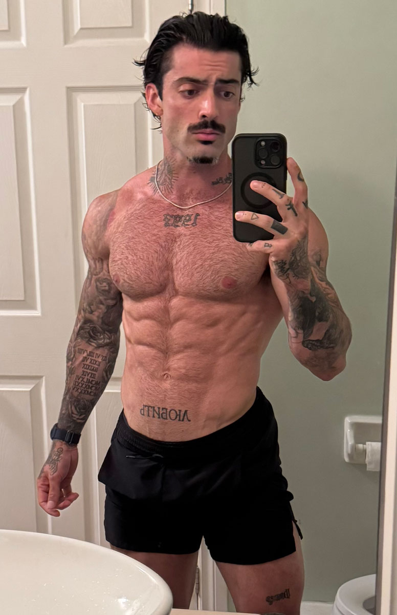 The coach is posing while looking at the mirror.